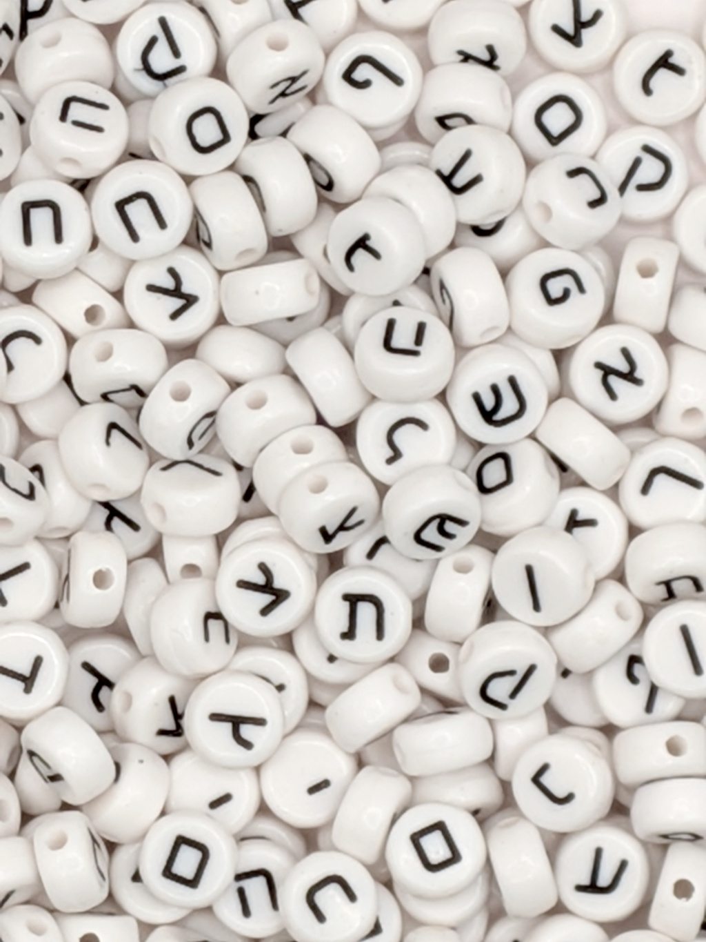 Closeup of a bunch of Hebrew letter plastic beads.
