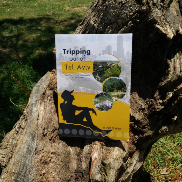 Pic of a hiking book resting on a tree branch.